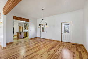 Unfurnished dining area with light wood-style floors and baseboards