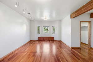 Unfurnished room with light wood finished floors and a textured ceiling