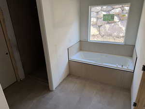 Bathroom with a bath and a stall shower