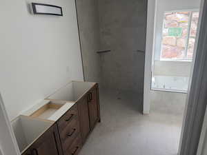 Full bath with vanity, a garden tub, walk in shower, and light tile patterned flooring