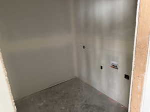 Laundry area featuring concrete floors and hookup for a washing machine