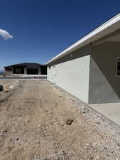 View of side of home with stucco siding