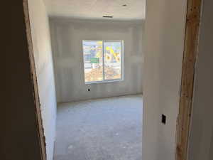 Empty room with a textured ceiling