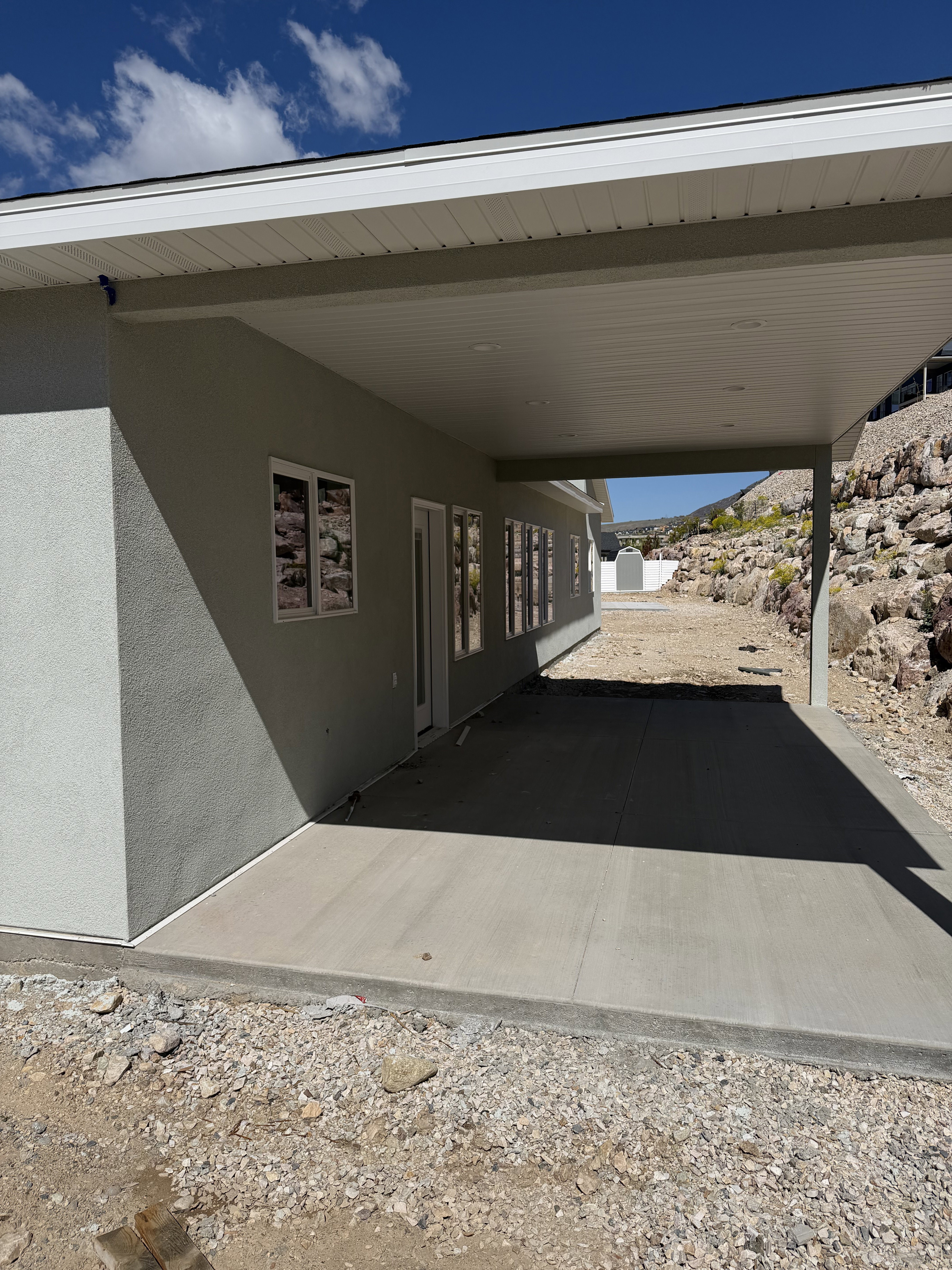 Exterior space with stucco siding and an attached carport