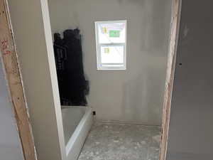 Bathroom featuring a tub to relax in