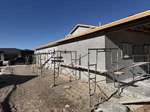 View of side of home featuring stucco siding