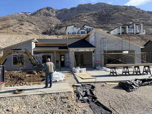 View of front facade with a mountain view and a patio