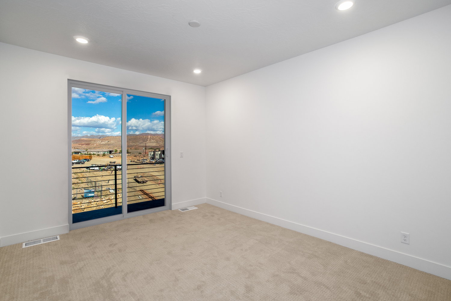 Unfurnished room featuring light carpet, recessed lighting, and a mountain view