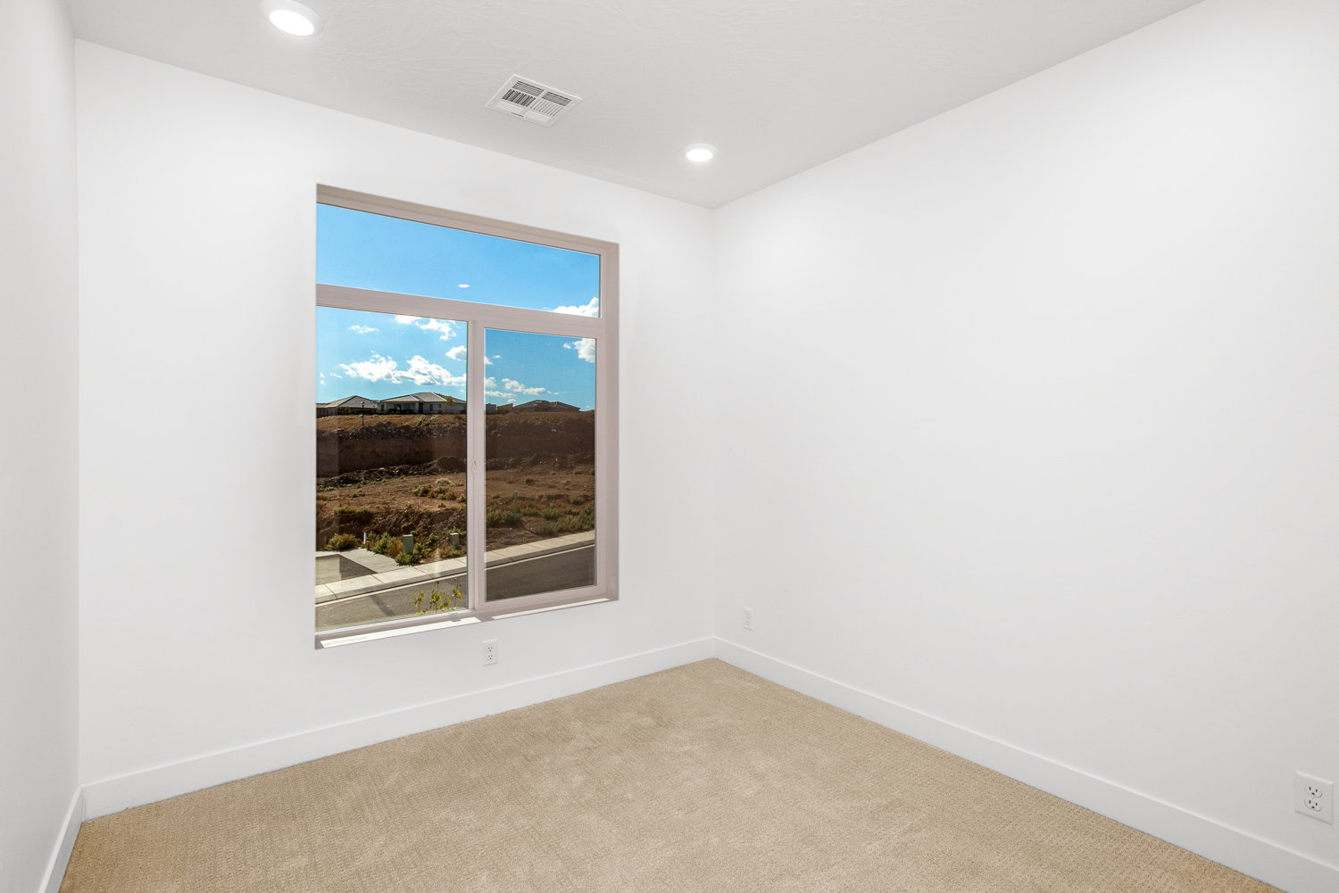 Carpeted empty room with baseboards and recessed lighting