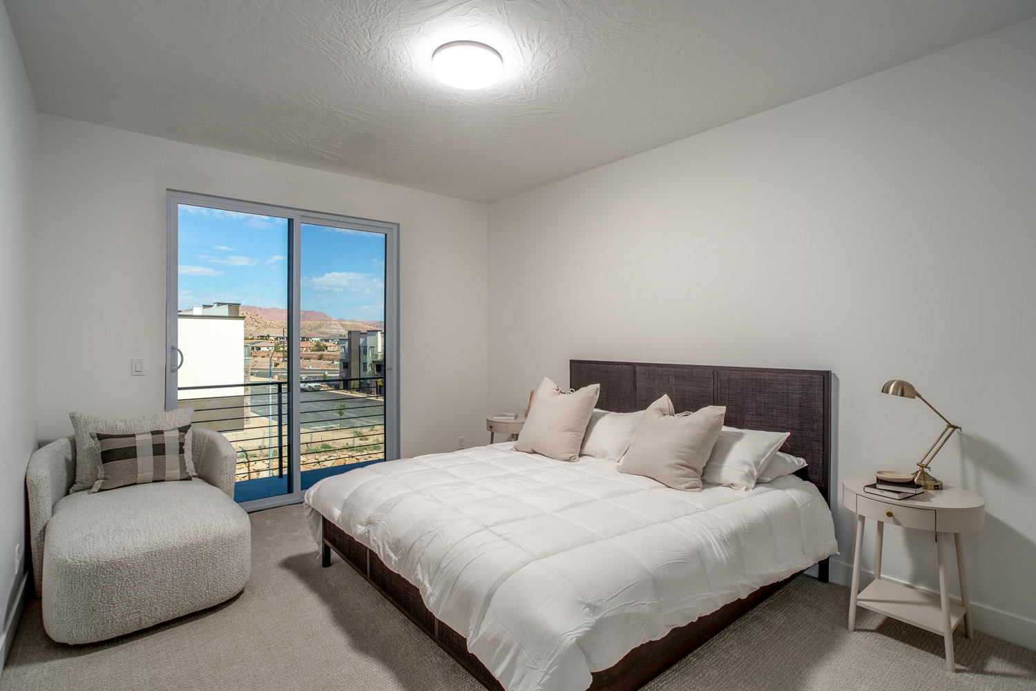 Carpeted bedroom featuring access to outside and a textured ceiling
