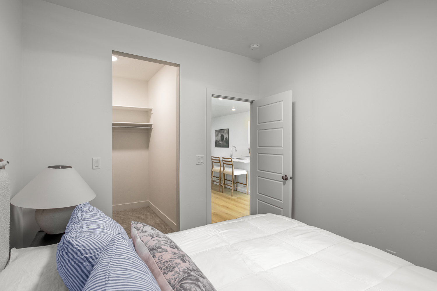 Bedroom with a spacious closet and baseboards