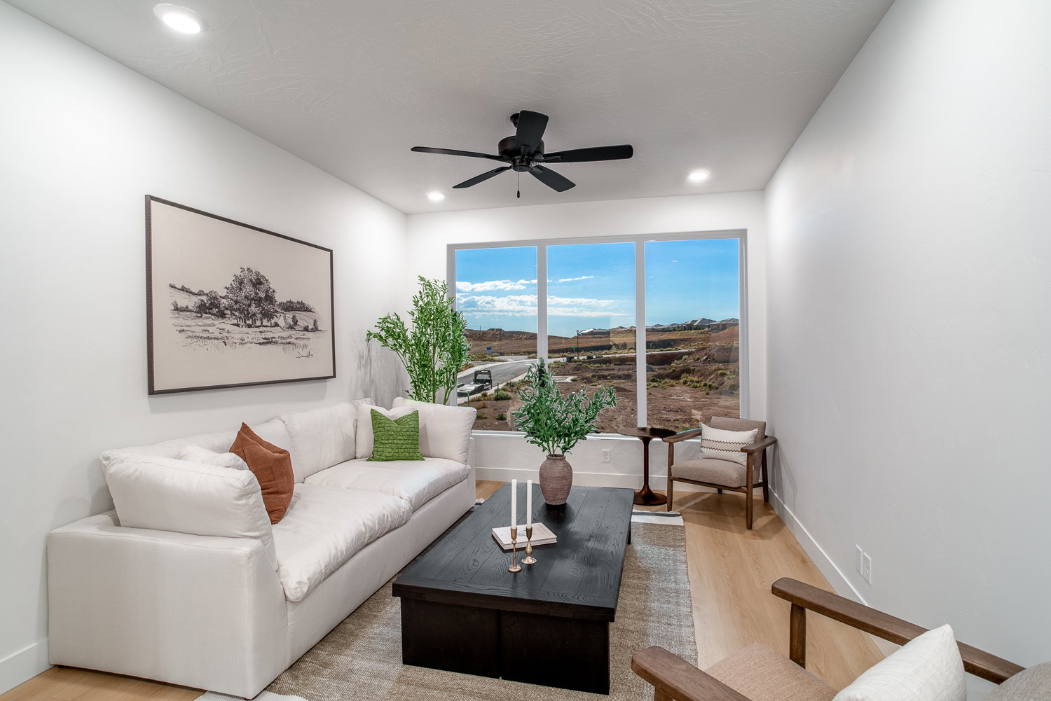 Living area featuring wood finished floors and ceiling fan