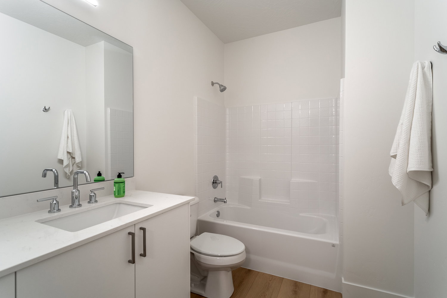 Full bathroom featuring vanity, light wood finished floors, and shower / tub combination