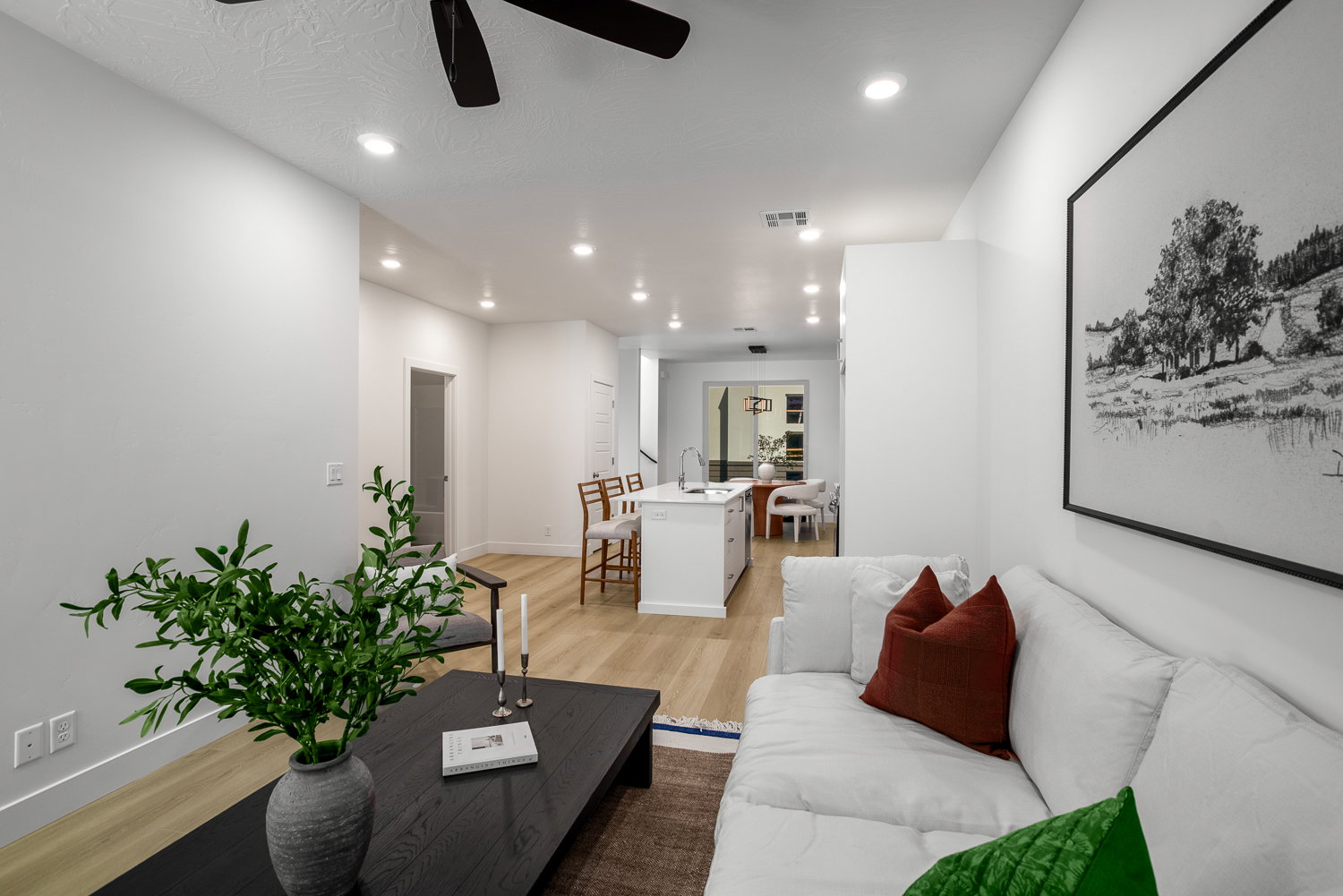 Living area featuring light wood-style floors, ceiling fan, and recessed lighting