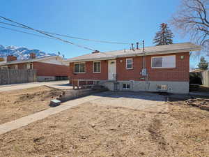 Rear view of property featuring brick siding