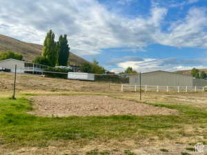 Surrounding community with volleyball court, a mountain view, and a view of rural / pastoral area