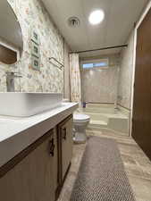 Full bath featuring vanity and shower / tub combo with curtain