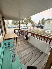 Deck at dusk featuring covered porch