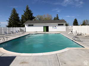 Community pool with a patio
