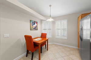 Dining area featuring an office area and light tile patterned flooring