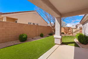 Fenced backyard with a patio area