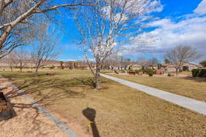 View of green lawn featuring a residential view