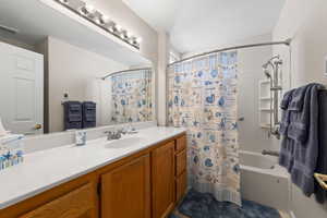 Full bathroom with vanity and shower / tub combo with curtain
