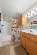 Full bath with vanity and shower / bath combo with shower curtain