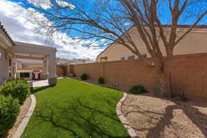 Fenced backyard with exterior kitchen and a patio area
