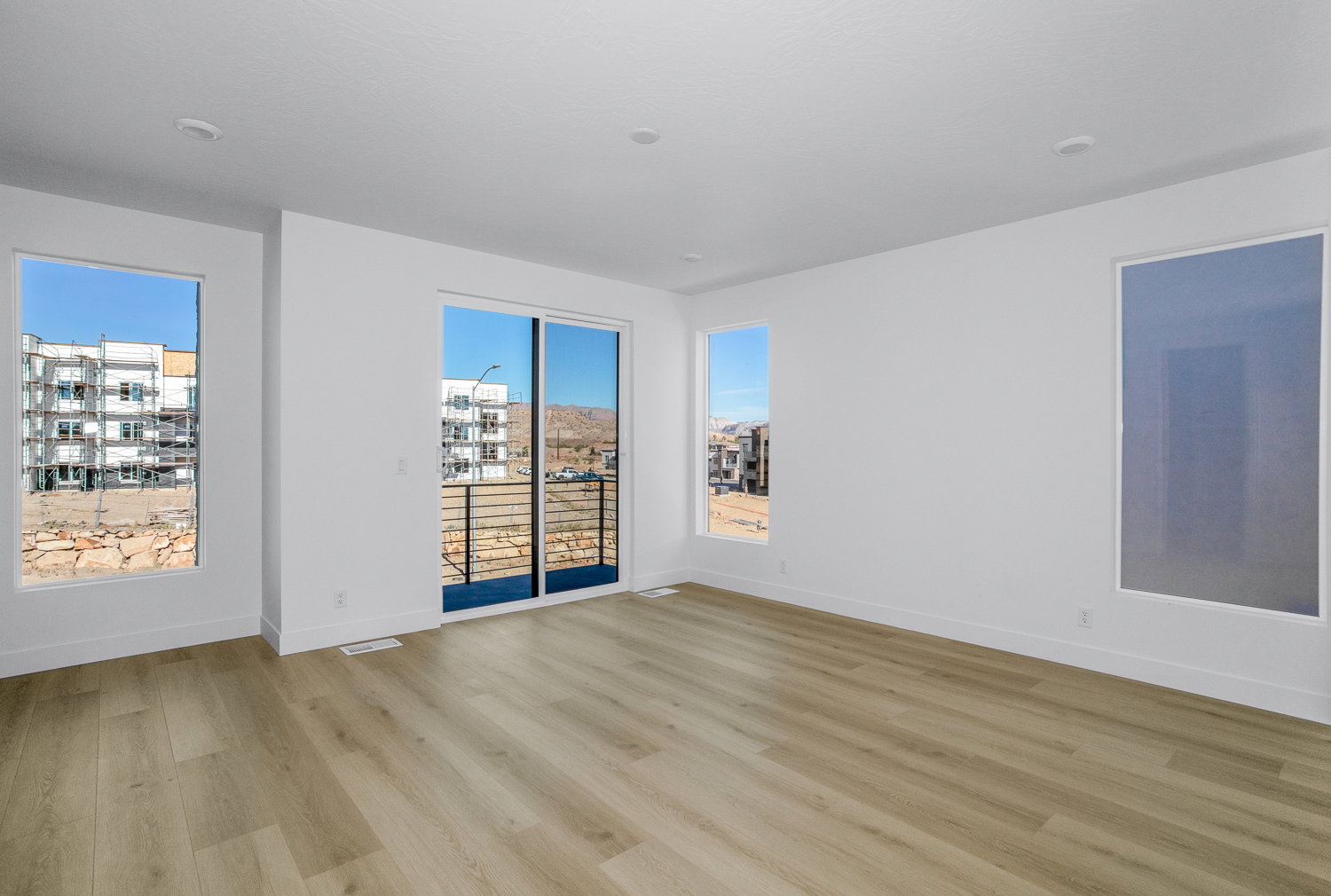 Empty room with light wood finished floors and baseboards