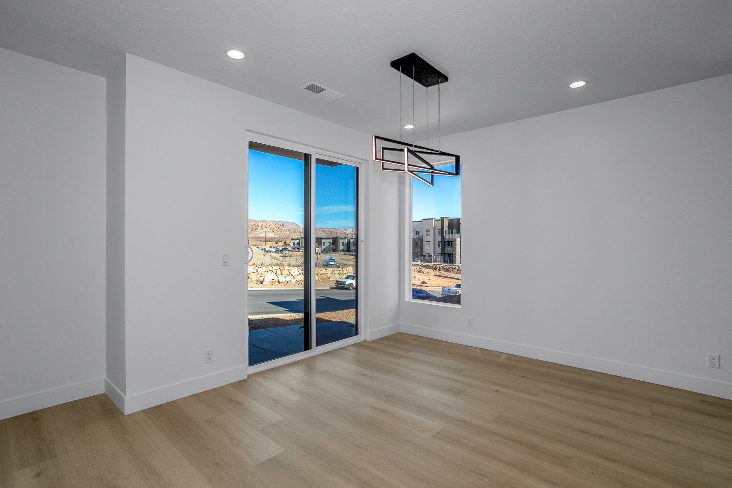 Unfurnished dining area with light wood-style floors and recessed lighting