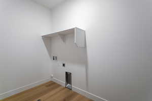 Laundry room with light wood-style flooring, electric dryer hookup, and washer hookup