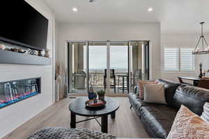 High ceilings. Electric Fireplace w/ remote. Massive vinyl slider. Solid surface flooring throughout.