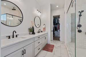 Main Level Primary Ensuite! Abundant windows. Access to upper deck. Can lights. Beautiful chandelier. Dual Sink Vanity. European style glass, oversized shower. Walk in closet (professional organizers).