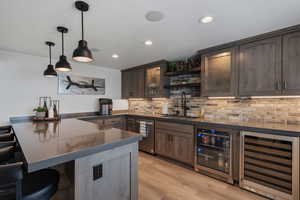 Tastefully Designed Wet Bar...with well thought out lighting. Entertainers dream area. Wine Chiller. Dishwasher.