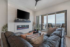 High ceilings. Electric Fireplace w/ remote. Massive vinyl slider. Solid surface flooring throughout.