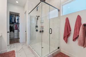 Main Level Primary Ensuite! Abundant windows. Access to upper deck. Can lights. Beautiful chandelier. Dual Sink Vanity. European style glass, oversized shower. Walk in closet (professional organizers).