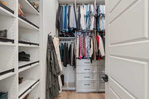 Main Level Primary Ensuite! Abundant windows. Access to upper deck. Can lights. Beautiful chandelier. Dual Sink Vanity. European style glass, oversized shower. Walk in closet (professional organizers).