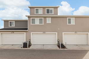 View of front of house featuring stucco siding and a garage