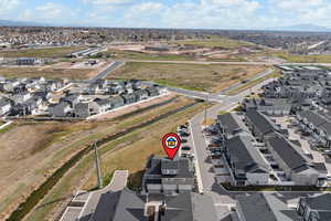 Aerial view of property and surrounding area featuring nearby suburban area
