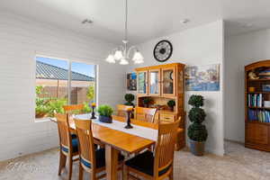 Dining space featuring hanging lights and wooden walls