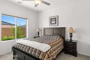 Bedroom featuring light carpet and a ceiling fan