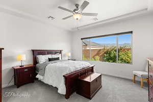 Bedroom with light colored carpet, a ceiling fan, and a mountain view