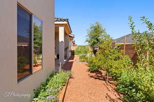 View of side of home featuring stucco siding and a tiled roof