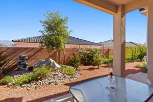 Fenced backyard with a patio area and outdoor dining space
