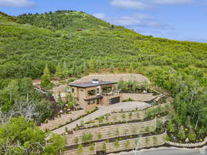 Aerial view of property and surrounding area featuring a heavily wooded area