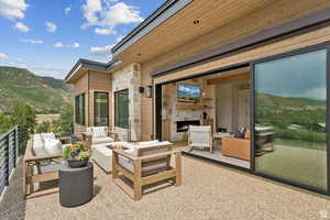 View of patio / terrace featuring a mountain view and an outdoor living space with a fireplace