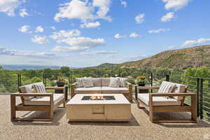 View of patio / terrace with a mountain view and an outdoor living space with a fire pit