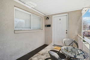 Doorway to property featuring stucco siding