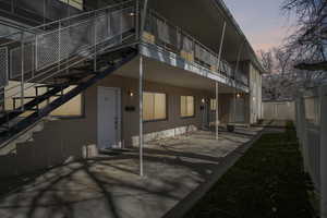 Back of property at dusk with a patio